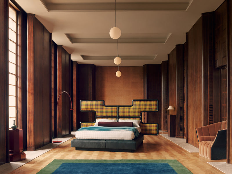 Modern bedroom with the Ozwald Boateng checkered headboard in Kente fabric and wooden walls